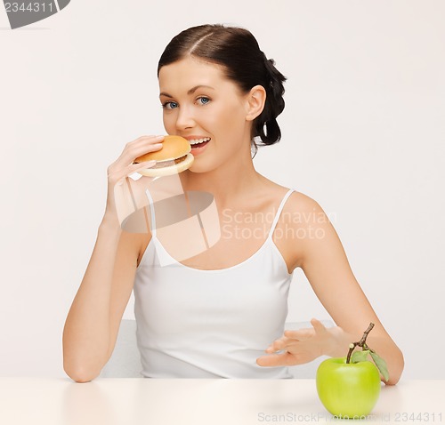 Image of woman with hamburger and vegetables