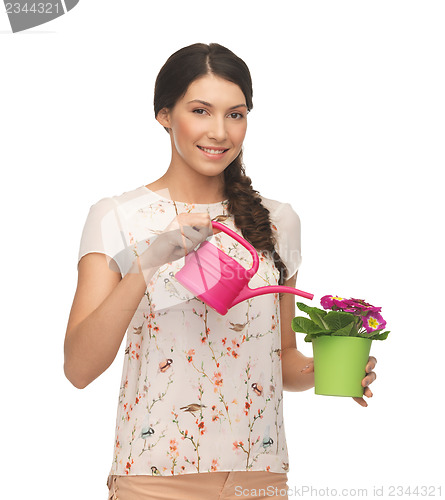 Image of housewife with flower in pot and watering can