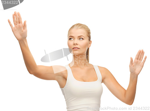 Image of woman in white t-shirt pressing imaginary button