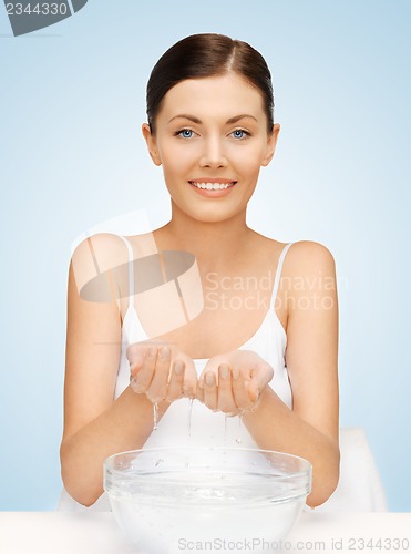Image of woman washing her face