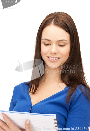 Image of smiling young businesswoman with notebook
