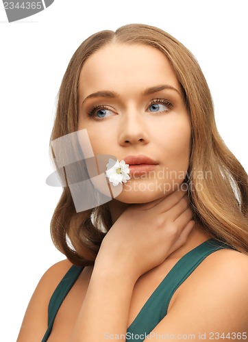 Image of woman with camomile in mouth