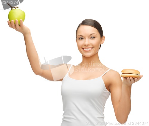 Image of woman with hamburger and apple