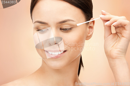 Image of beautiful woman with cotton bud