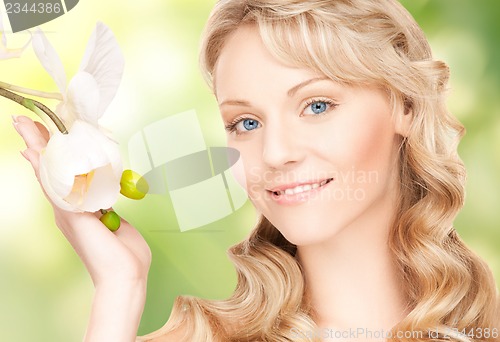 Image of beautiful woman with orchid flower