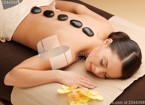 Image of beautiful woman with hot stones