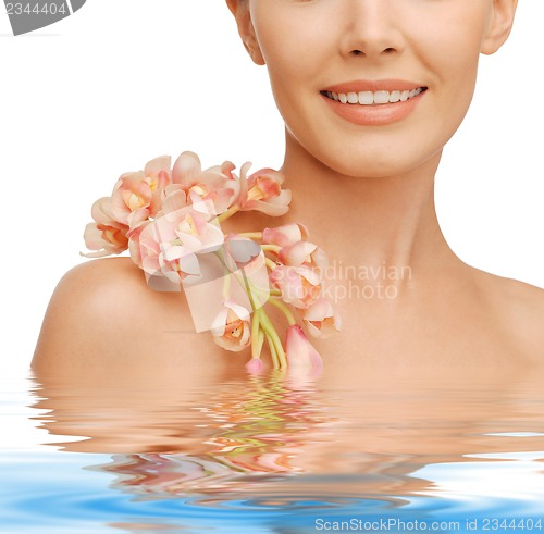 Image of lovely woman with orchid flower