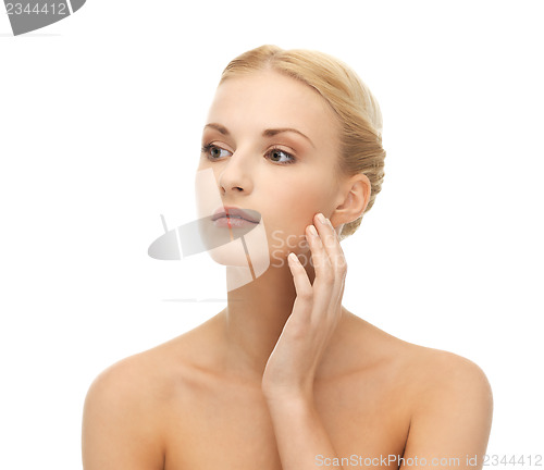 Image of woman touching her face skin