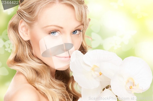 Image of beautiful woman with orchid flower and butterflies