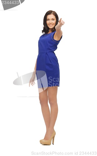 Image of woman in blue dress pointing her finger