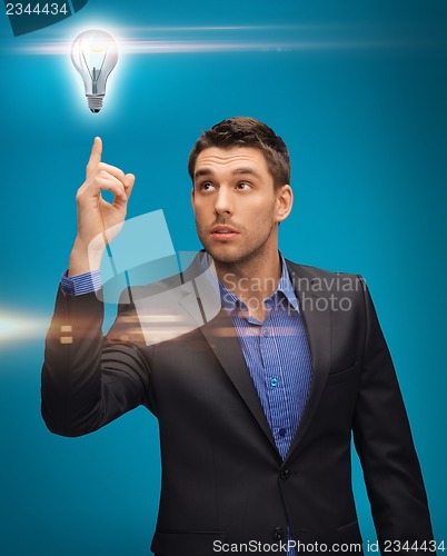 Image of man in suit with light bulb