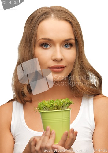 Image of woman with green grass in pot