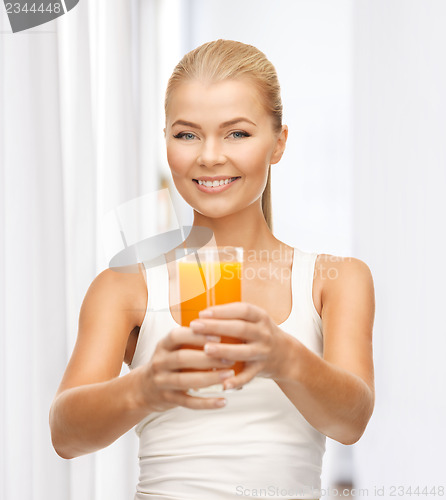Image of woman holding glass of orange juice