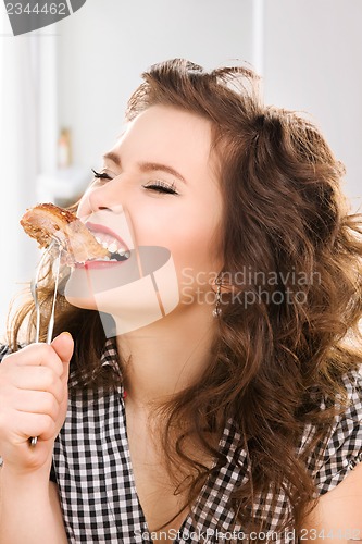 Image of young attractive woman in the kitchen