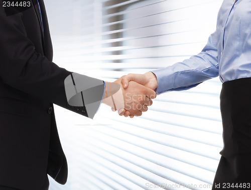 Image of man and woman shaking their hands