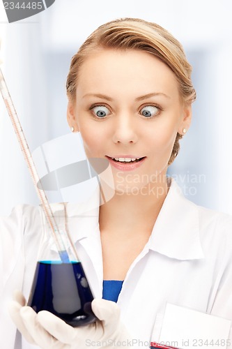 Image of lab worker holding up test tube