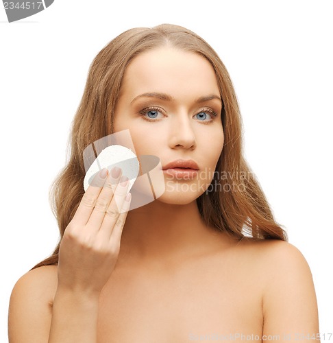 Image of beautiful woman with cotton pad