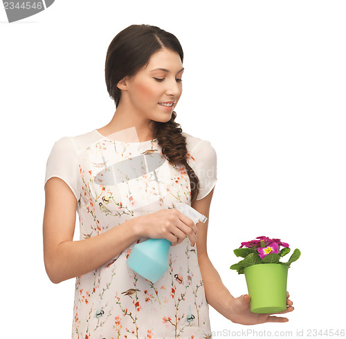 Image of woman holding pot with flower and spray bottle