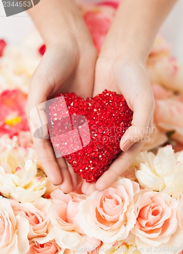 Image of woman's hands holding heart