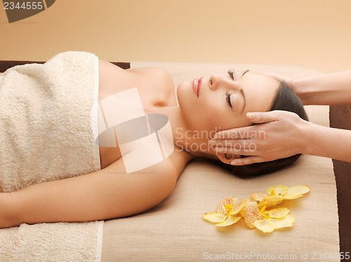 Image of woman in spa salon lying on the massage desk