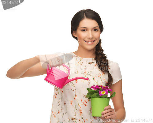 Image of housewife with flower in pot and watering can