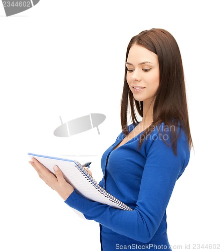 Image of smiling young businesswoman with notebook