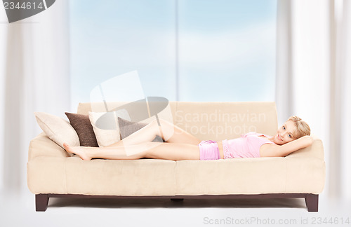 Image of happy woman on sofa