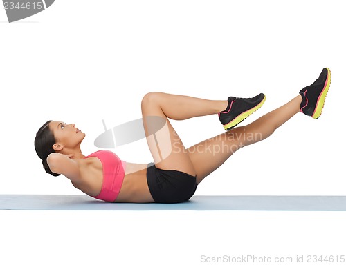Image of beautiful sporty woman doing exercise
