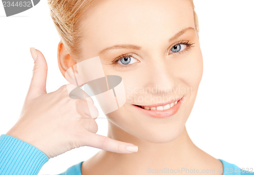 Image of woman making a call me gesture