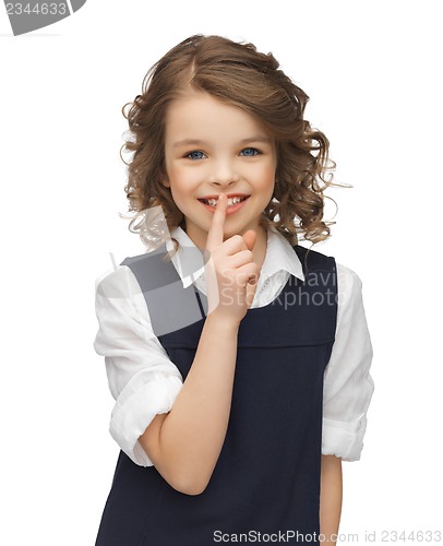 Image of pre-teen girl showing hush gesture