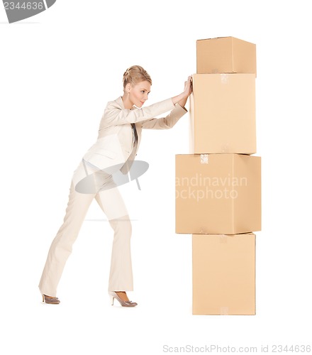 Image of businesswoman moving big boxes
