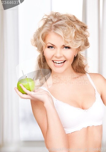 Image of young beautiful woman with green apple