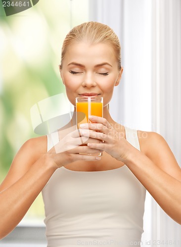 Image of young woman drinking orange juice