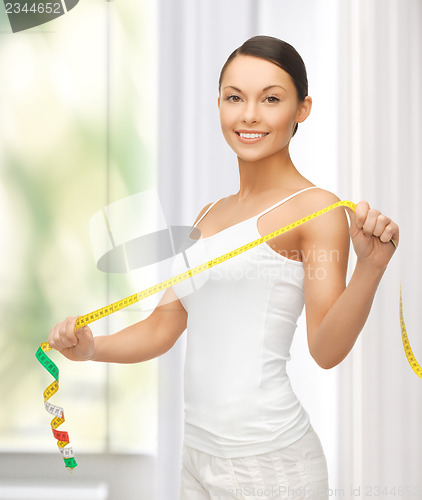 Image of sporty woman with measuring tape