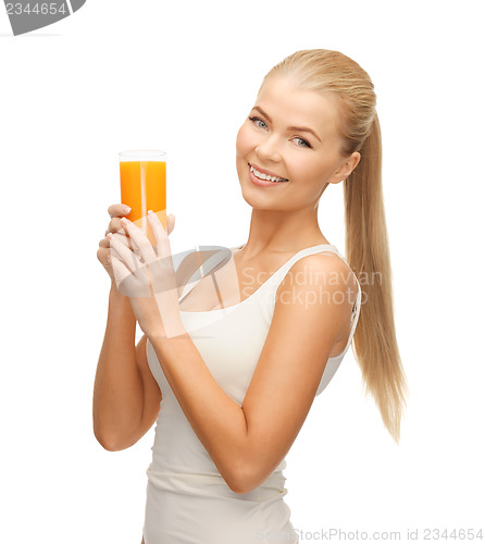 Image of woman holding glass of orange juice