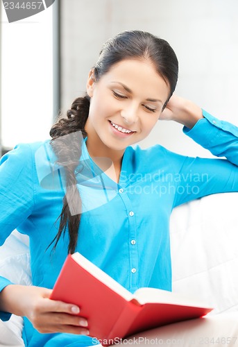Image of happy and smiling woman with book