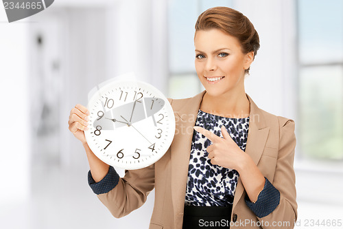 Image of woman holding big clock