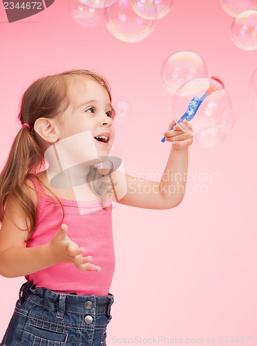 Image of litle girl with soap bubbles