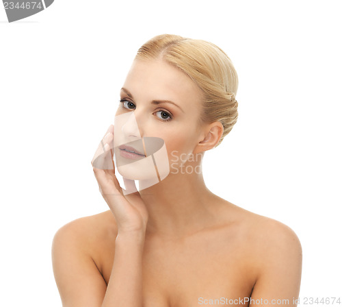 Image of woman touching her face skin