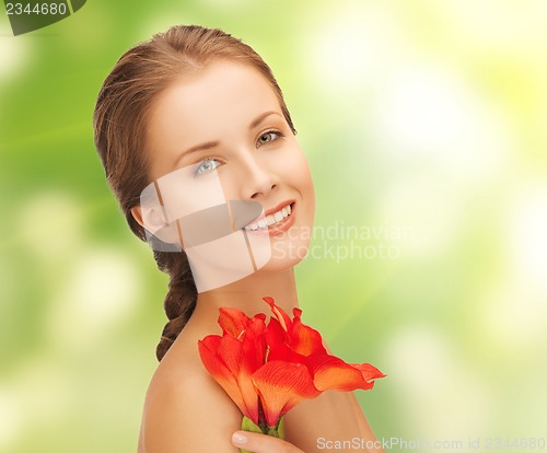 Image of lovely woman with red lily flower