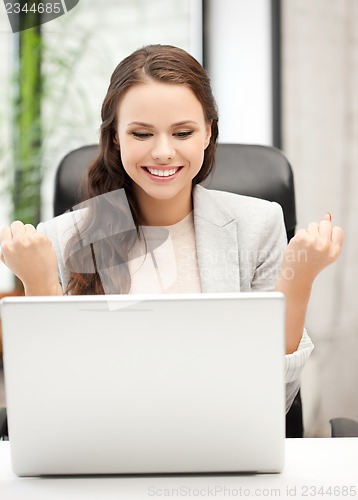 Image of smiling businesswoman celebrating victory or win