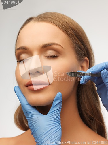 Image of woman face and beautician hands