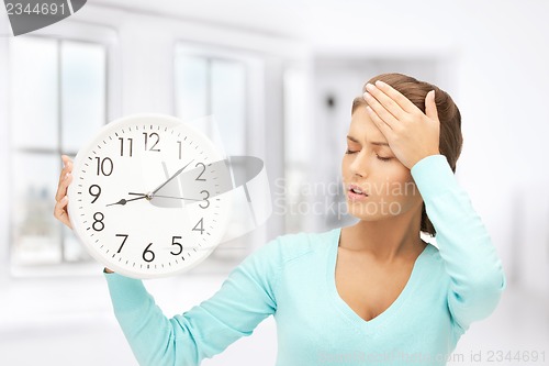 Image of woman holding big clock