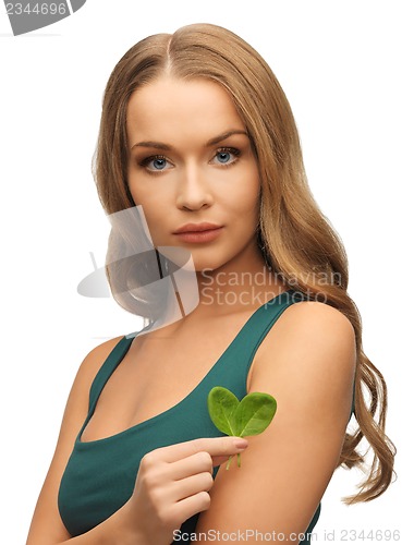 Image of woman with spinach leaves