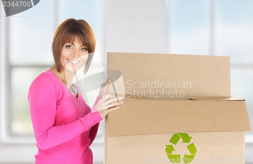 Image of attractive businesswoman with recyclable box