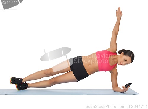 Image of beautiful sporty woman doing exercise