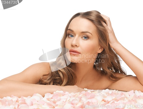 Image of beautiful woman with rose petals