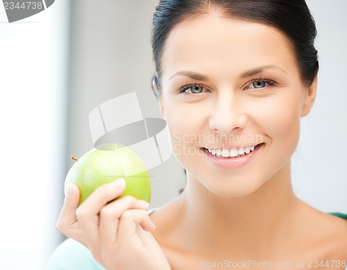 Image of beautiful woman in the with an apple