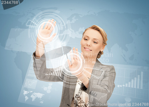 Image of businesswoman touching virtual screen