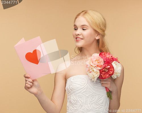 Image of young woman holding flower and postcard